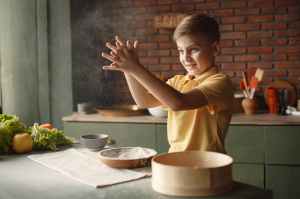 boy in yellow shirt sifting flour